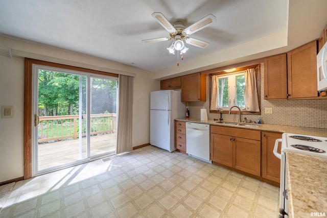 748 E Poplet Hollow Rd, Peoria, IL 61614 - kitchen with white appliances, light flooring, healthy amount of natural light, and decorative backsplash