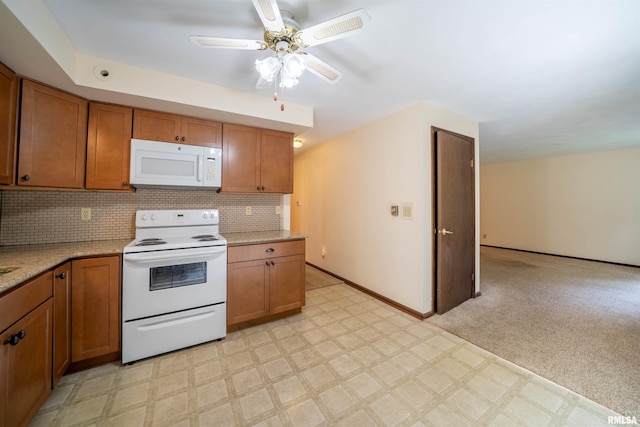 748 E Poplet Hollow Rd, Peoria, IL 61614 - kitchen featuring white appliances, brown cabinets, a ceiling fan, and light flooring