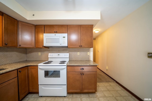 748 E Poplet Hollow Rd, Peoria, IL 61614 - kitchen with white appliances, brown cabinets, decorative backsplash, and light flooring