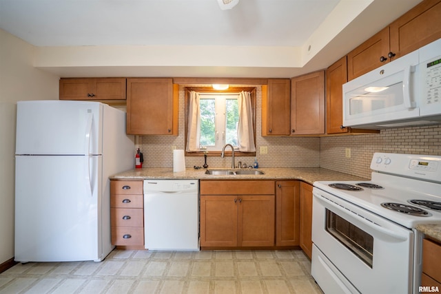 748 E Poplet Hollow Rd, Peoria, IL 61614 - kitchen with white appliances, light flooring, brown cabinets, backsplash, and light stone counters