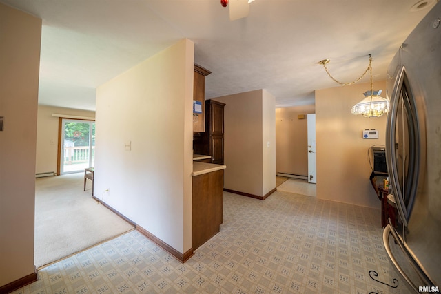 748 E Poplet Hollow Rd, Peoria, IL 61614 - kitchen with freestanding refrigerator, light colored carpet, baseboard heating, light countertops, and a chandelier
