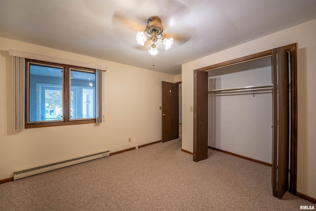 748 E Poplet Hollow Rd, Peoria, IL 61614 - unfurnished bedroom featuring a baseboard radiator, carpet, a closet, and ceiling fan