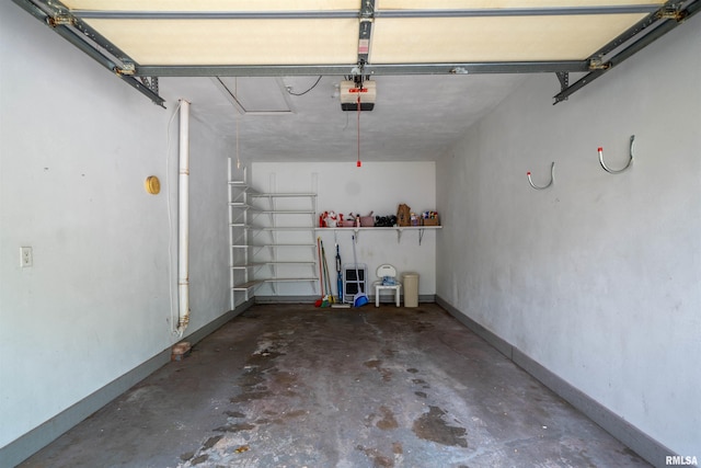 748 E Poplet Hollow Rd, Peoria, IL 61614 - garage with a garage door opener and baseboards