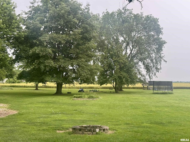 442 W Oak St, Smithfield, IL 61477 - view of home's community featuring a trampoline, a fire pit, and a lawn