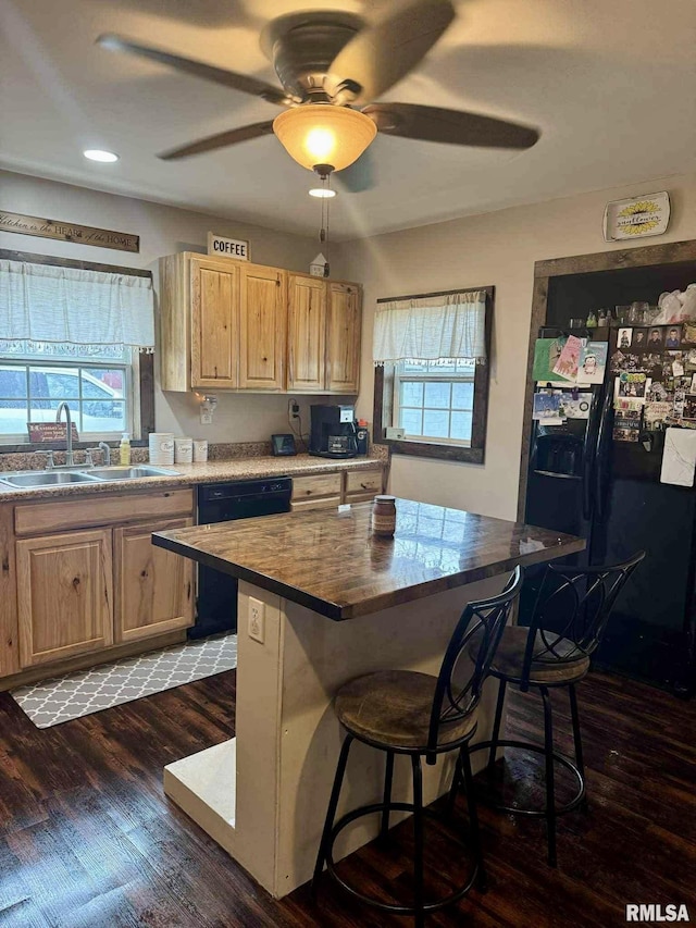 442 W Oak St, Smithfield, IL 61477 - kitchen with dishwashing machine, black refrigerator with ice dispenser, light brown cabinets, a breakfast bar area, and dark wood-style flooring