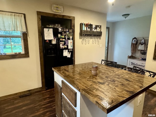 442 W Oak St, Smithfield, IL 61477 - kitchen with black fridge, dark wood-type flooring, dark countertops, and a center island