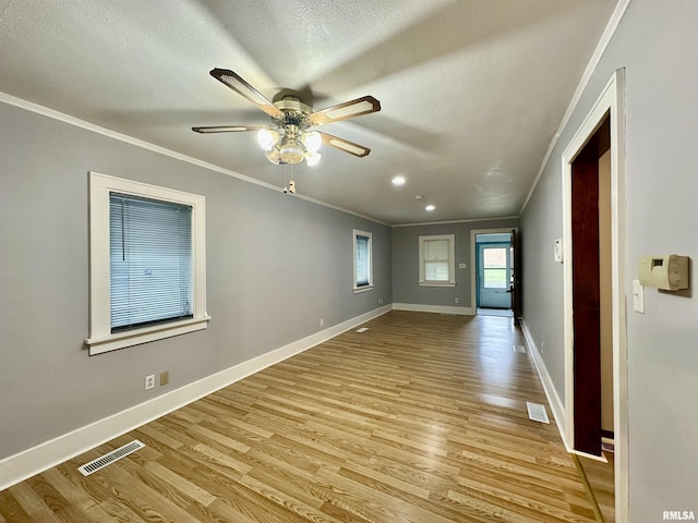 904 E Forrest Hill Ave, Peoria, IL 61603 - unfurnished room with ornamental molding, light wood finished floors, a ceiling fan, and a textured ceiling
