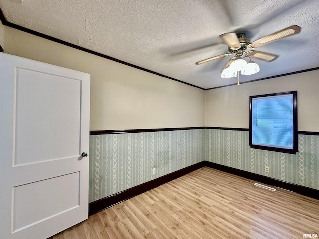 904 E Forrest Hill Ave, Peoria, IL 61603 - empty room featuring wood finished floors, wainscoting, ornamental molding, and a ceiling fan