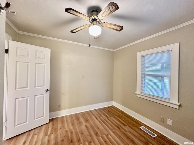 904 E Forrest Hill Ave, Peoria, IL 61603 - empty room with wood finished floors, crown molding, and ceiling fan