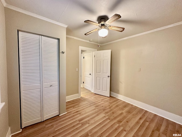 904 E Forrest Hill Ave, Peoria, IL 61603 - unfurnished bedroom with a closet, light wood finished floors, ornamental molding, and ceiling fan
