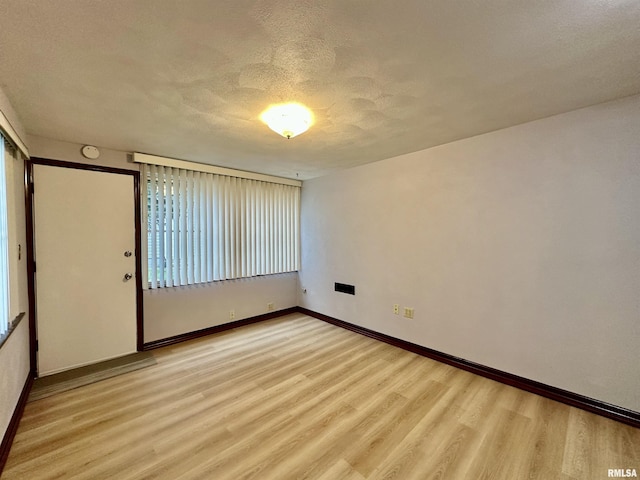 904 E Forrest Hill Ave, Peoria, IL 61603 - spare room featuring light wood finished floors and a textured ceiling
