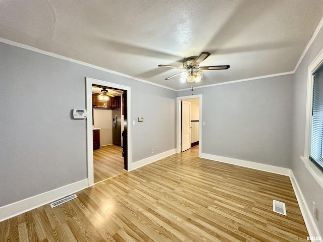904 E Forrest Hill Ave, Peoria, IL 61603 - spare room featuring ceiling fan, light wood-style floors, ornamental molding, and a textured ceiling