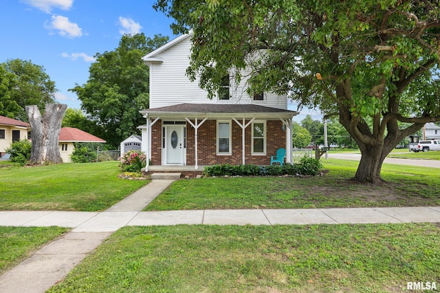 411 E 3rd St, Delavan, IL 61550 - view of front facade featuring a front lawn, brick siding, and covered porch