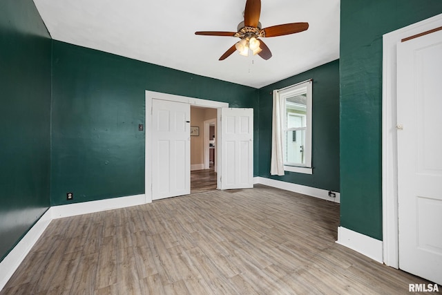 411 E 3rd St, Delavan, IL 61550 - unfurnished bedroom with wood finished floors and a ceiling fan