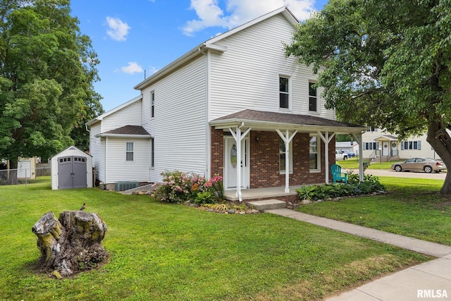 411 E 3rd St, Delavan, IL 61550 - view of front facade featuring a porch, a shed, and brick siding