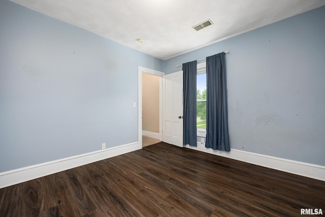 411 E 3rd St, Delavan, IL 61550 - empty room featuring wood finished floors and baseboards