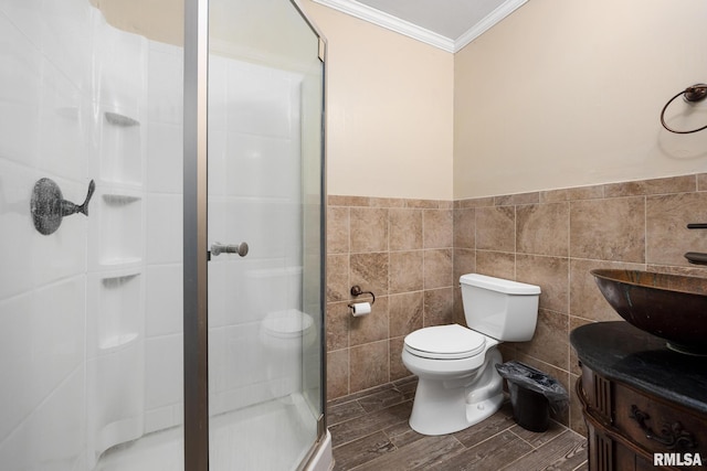 411 E 3rd St, Delavan, IL 61550 - full bath with ornamental molding, a shower stall, vanity, tile walls, and a wainscoted wall