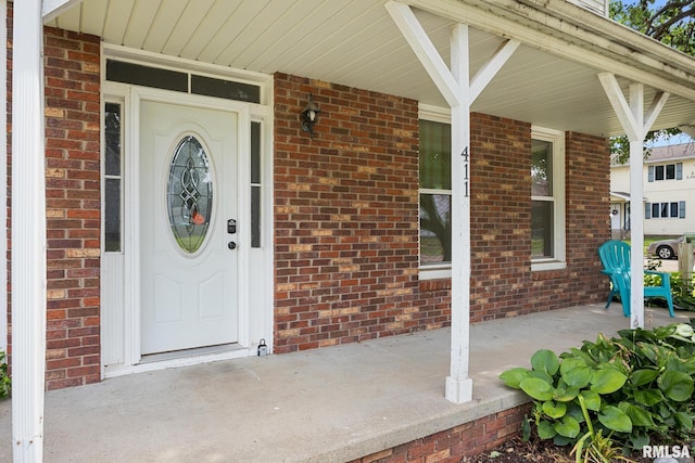 411 E 3rd St, Delavan, IL 61550 - entrance to property featuring brick siding and covered porch