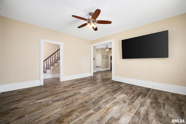 411 E 3rd St, Delavan, IL 61550 - unfurnished living room featuring ceiling fan, wood finished floors, and stairway