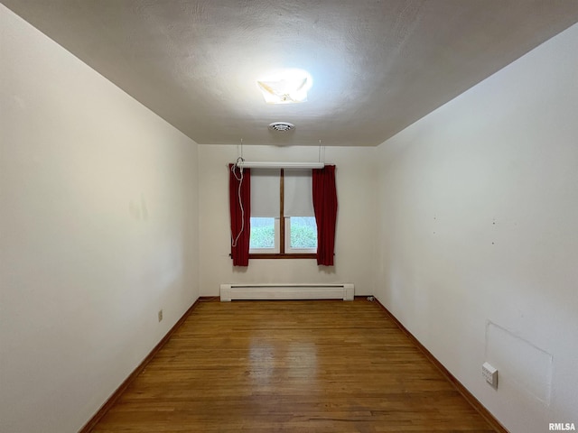 505 S Davenport St, Metamora, IL 61548 - empty room featuring a baseboard radiator and wood finished floors