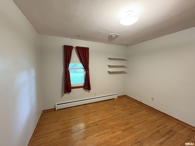 505 S Davenport St, Metamora, IL 61548 - empty room featuring baseboard heating and wood finished floors