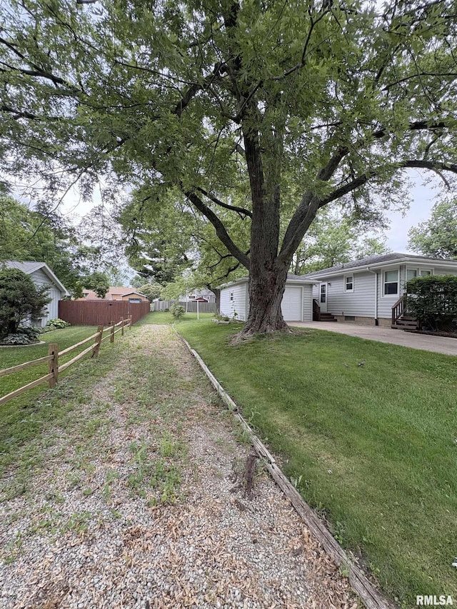 505 S Davenport St, Metamora, IL 61548 - view of yard with an attached garage, entry steps, and a patio area