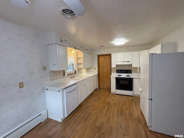 505 S Davenport St, Metamora, IL 61548 - kitchen featuring white appliances, a baseboard radiator, under cabinet range hood, and wood finished floors