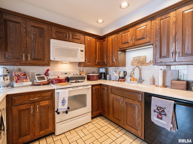 2705 N Victoria Ave, Peoria, IL 61604 - kitchen with white appliances, backsplash, recessed lighting, light countertops, and brick patterned floors