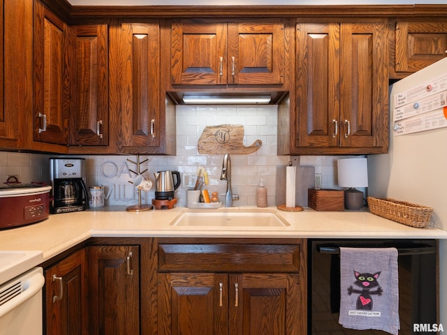 2705 N Victoria Ave, Peoria, IL 61604 - kitchen with black dishwasher, decorative backsplash, and light countertops