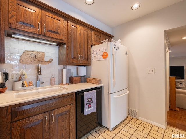 2705 N Victoria Ave, Peoria, IL 61604 - kitchen featuring freestanding refrigerator, dishwasher, backsplash, light countertops, and recessed lighting