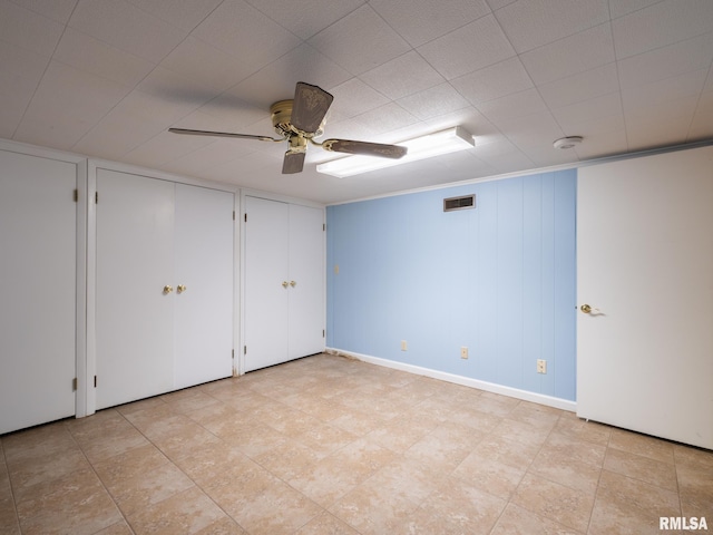 2705 N Victoria Ave, Peoria, IL 61604 - unfurnished bedroom featuring multiple closets and a ceiling fan