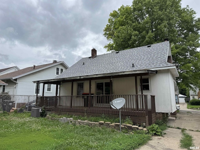 1210 W Macqueen Ave, Peoria, IL 61604 - rear view of house with a shingled roof, a chimney, and a porch