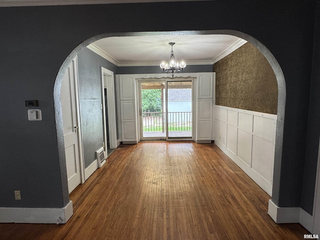 1210 W Macqueen Ave, Peoria, IL 61604 - unfurnished dining area with ornamental molding, wood finished floors, a chandelier, arched walkways, and a wainscoted wall