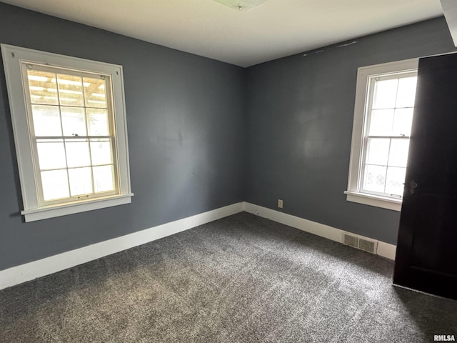 1210 W Macqueen Ave, Peoria, IL 61604 - spare room featuring healthy amount of natural light and dark colored carpet