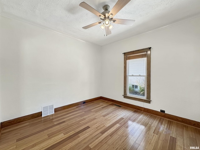 510 W Willcox Ave, Peoria, IL 61604 - unfurnished room featuring wood finished floors, a ceiling fan, a textured ceiling, and crown molding
