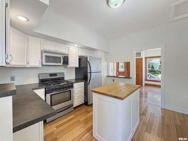 510 W Willcox Ave, Peoria, IL 61604 - kitchen featuring stainless steel appliances, white cabinets, wooden counters, crown molding, and light wood-type flooring
