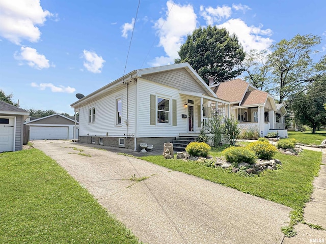 510 W Willcox Ave, Peoria, IL 61604 - bungalow featuring an outbuilding, a front yard, a porch, and a garage