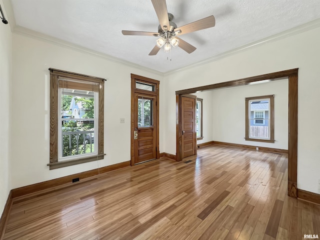 510 W Willcox Ave, Peoria, IL 61604 - empty room featuring ornamental molding, light wood finished floors, ceiling fan, and a textured ceiling
