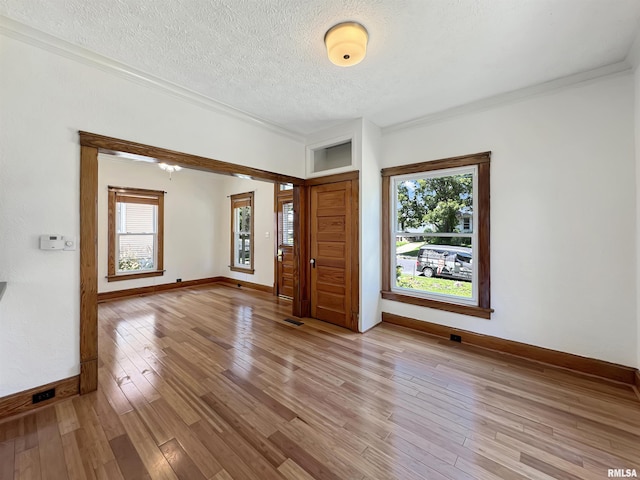 510 W Willcox Ave, Peoria, IL 61604 - foyer with light wood-style flooring, healthy amount of natural light, a textured ceiling, and crown molding