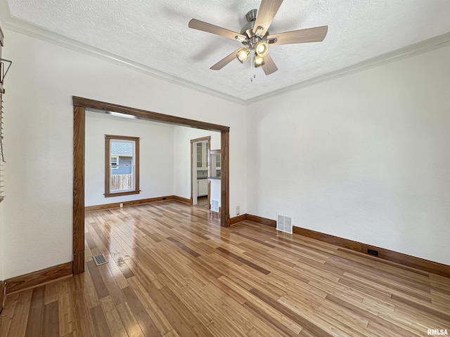 510 W Willcox Ave, Peoria, IL 61604 - spare room with light wood-style flooring, a textured ceiling, ceiling fan, and crown molding
