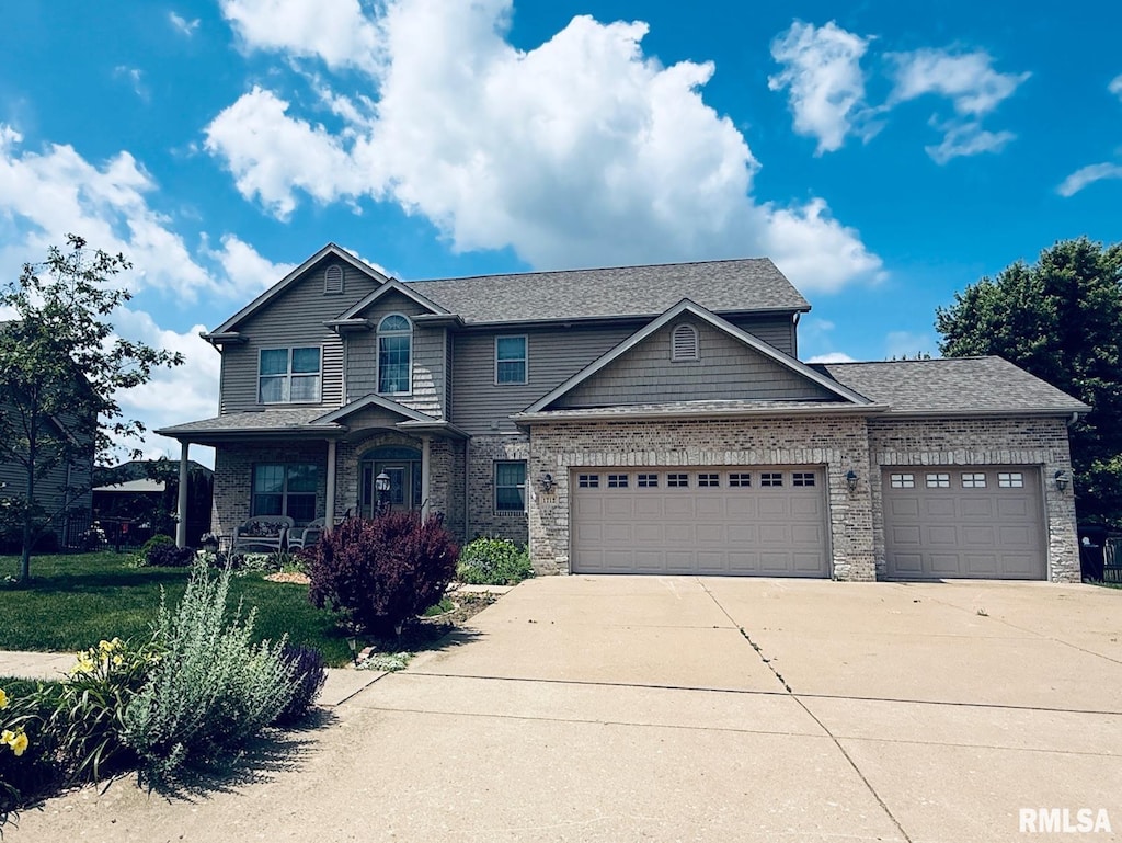 1712 Rustic Oak Dr, Washington, IL 61571 - view of front of property with a garage, concrete driveway, covered porch, and roof with shingles