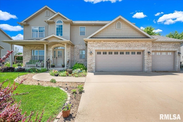 1712 Rustic Oak Dr, Washington, IL 61571 - view of front of home with concrete driveway, an attached garage, brick siding, and a porch