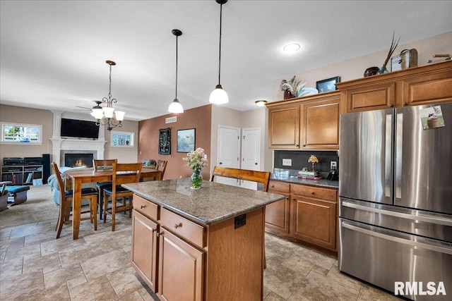 1712 Rustic Oak Dr, Washington, IL 61571 - kitchen with freestanding refrigerator, a kitchen island, brown cabinetry, and decorative light fixtures