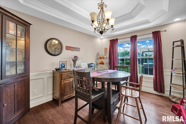 1712 Rustic Oak Dr, Washington, IL 61571 - dining space with ornamental molding, a raised ceiling, a chandelier, dark wood-style flooring, and a wainscoted wall
