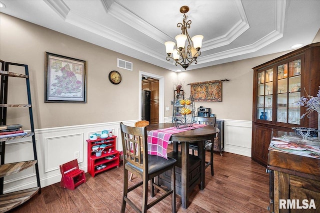 1712 Rustic Oak Dr, Washington, IL 61571 - dining area featuring a chandelier, ornamental molding, wood finished floors, a raised ceiling, and a wainscoted wall