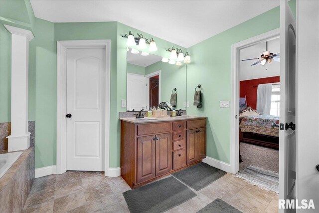 1712 Rustic Oak Dr, Washington, IL 61571 - full bath featuring ensuite bathroom, double vanity, a relaxing tiled tub, and ornate columns