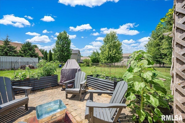 1712 Rustic Oak Dr, Washington, IL 61571 - fenced backyard featuring a patio area and a vegetable garden