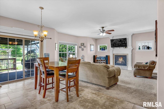 1712 Rustic Oak Dr, Washington, IL 61571 - dining area featuring a fireplace, ceiling fan, and a chandelier