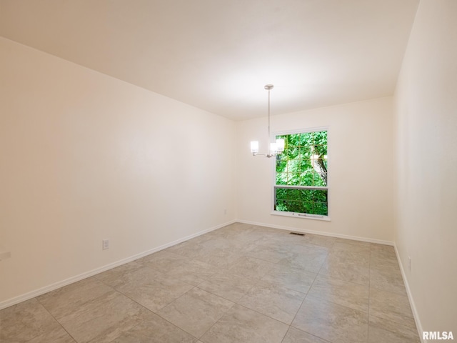 743 W Wonderview Dr, Dunlap, IL 61525 - empty room featuring a chandelier and baseboards