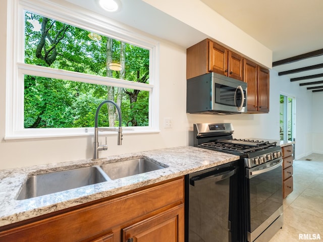743 W Wonderview Dr, Dunlap, IL 61525 - kitchen with appliances with stainless steel finishes, brown cabinets, light stone counters, and light tile patterned flooring